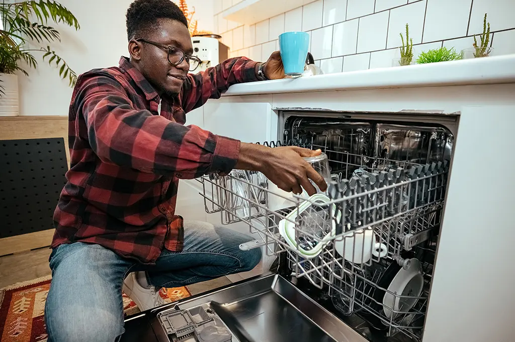man-emptying-dishwasher