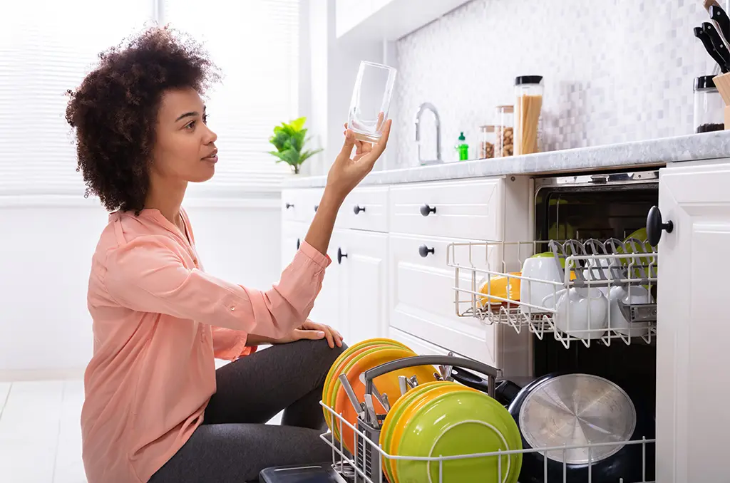 woman-unloading-dishwasher